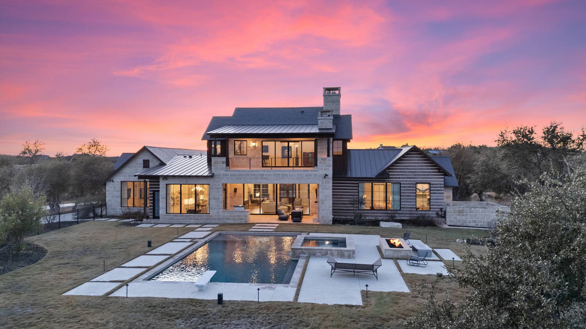 Hill Country stone estate at sunset in Boot Ranch, Fredericksburg, Texas